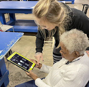 staff helping consumer using an iPad
